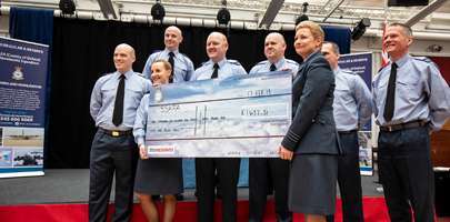 BMT 31 presenting their charity cheque with Senior Student LAC Rutter on the left and OC 4624 Sqn on the right