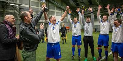 Image showing the winning team holding up their trophy.